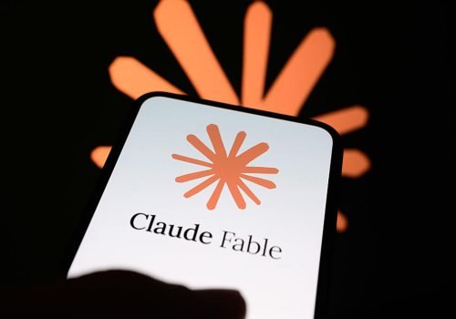 The Claude Fable logo is displayed on the screen of a handheld smartphone with the company's bran...